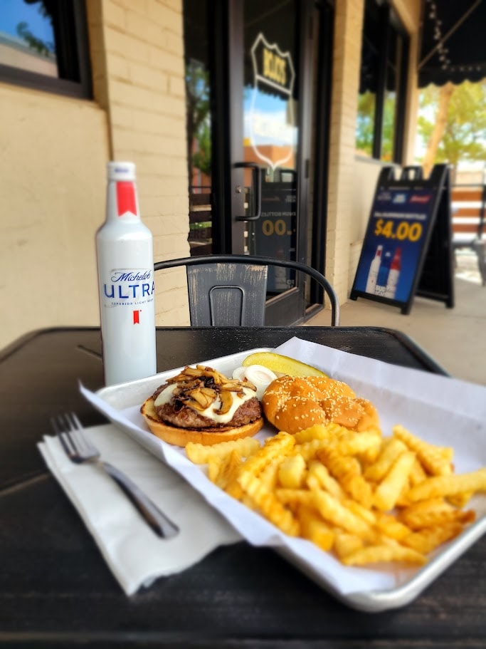Burger, fries and beer on outdoor patio