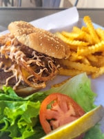 Pulled pork sandwich with fries and salad