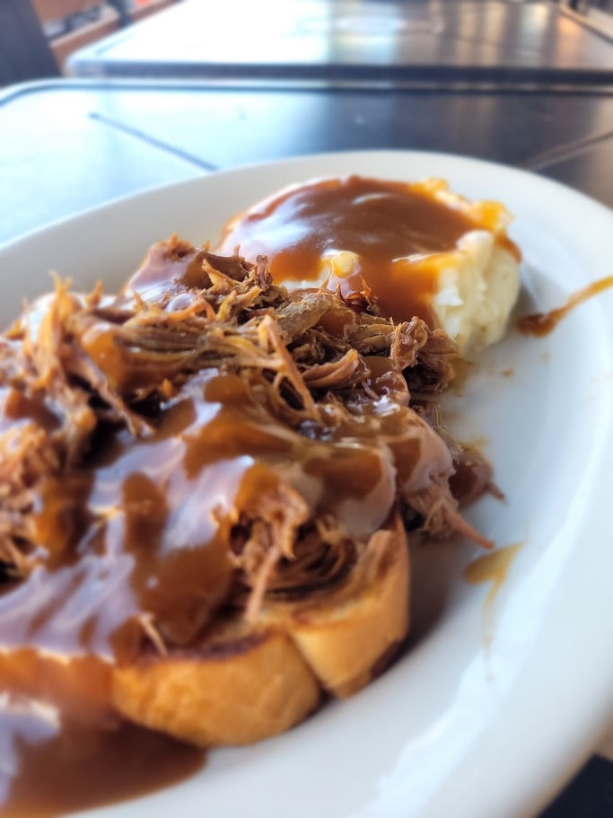 Pulled pork sandwich with gravy and mashed potatoes