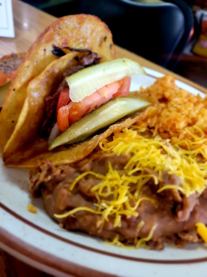 Gourmet sandwich with tomato, cheese and hash browns