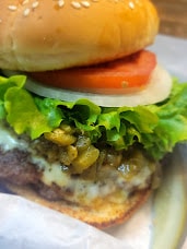 Gourmet burger with lettuce, tomato and pickles