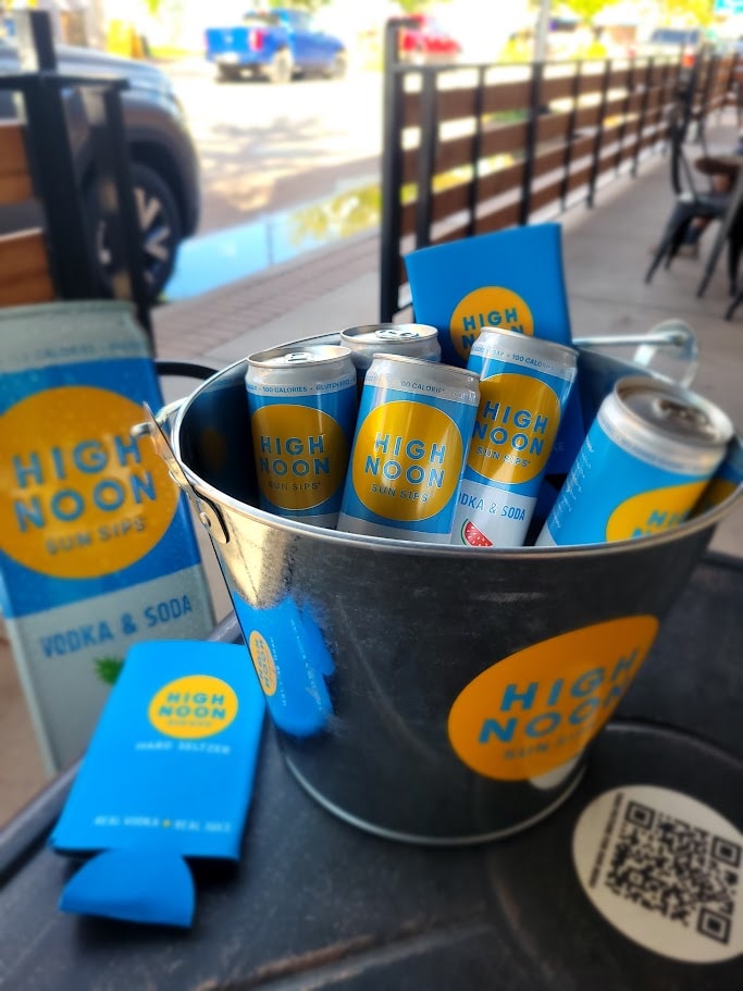 High Noon beer cans on ice