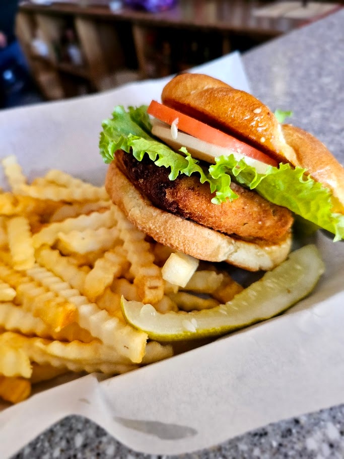 Crispy burger with fries and pickle