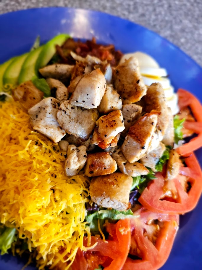 Grilled chicken with yellow rice and fresh vegetables