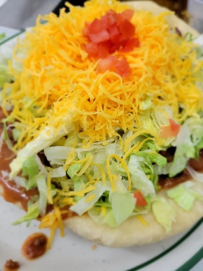 Layered salad with shredded cheese and tomato